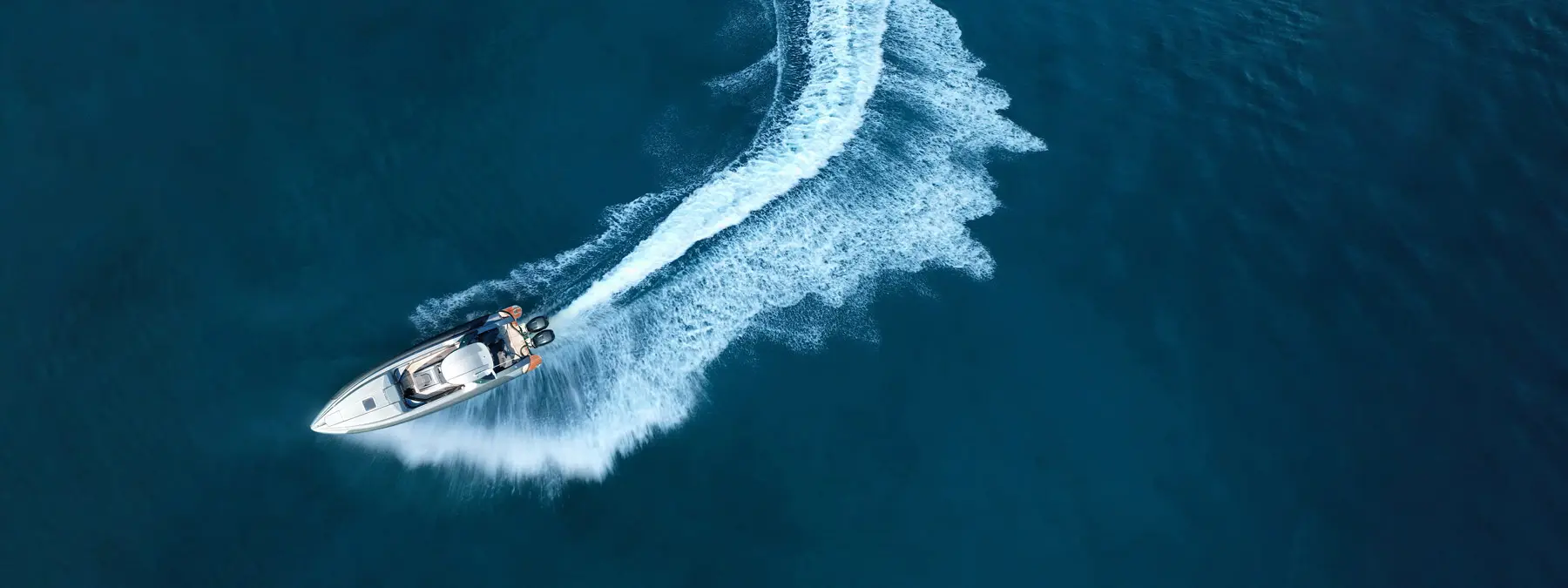 picture shows a boat driving in the ocean